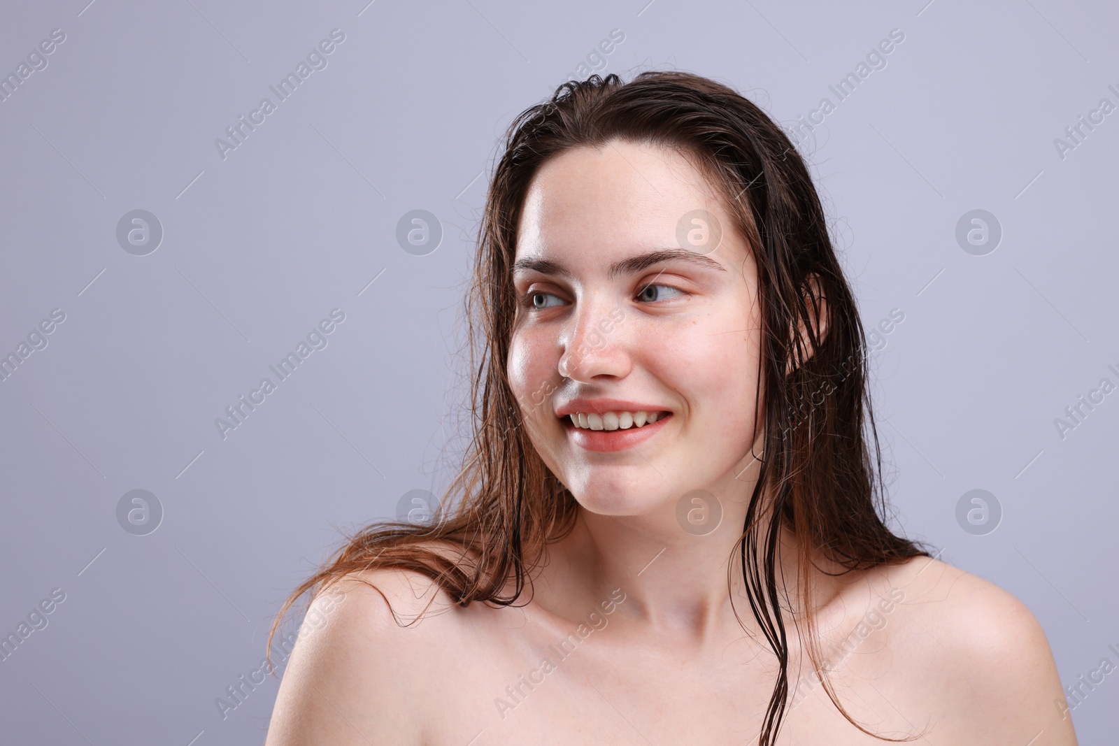 Smiling woman with natural skin complexion on grey background, closeup. Space for text Photo of Smiling woman with natural skin complexion on grey background, closeup. Space for text