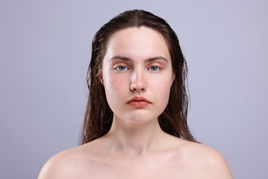 Photo of Portrait of woman with natural skin complexion on grey background, closeup