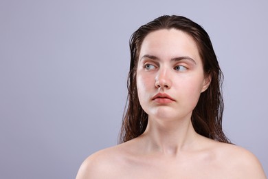 Photo of Beautiful woman with natural skin complexion on grey background, closeup. Space for text