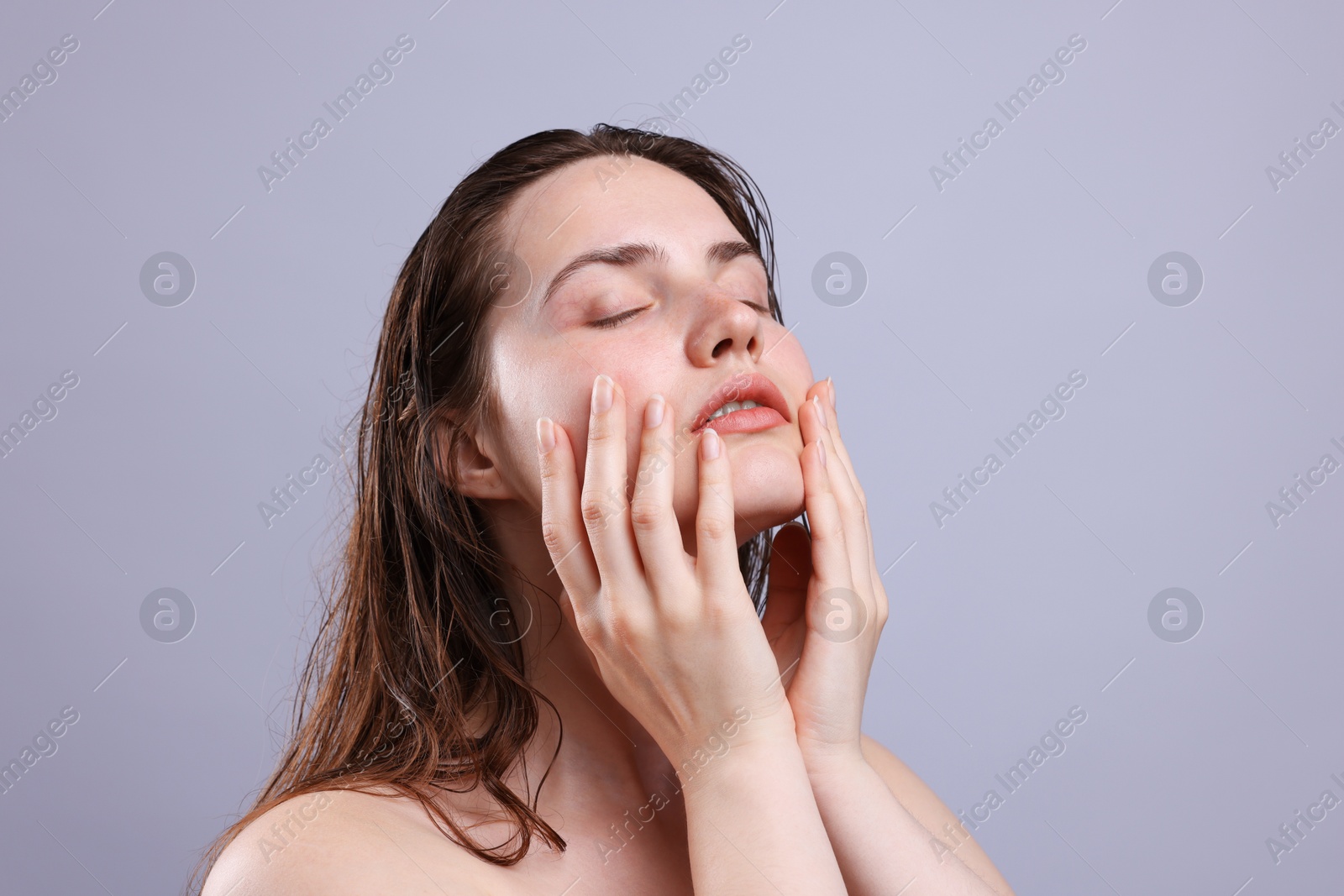 Beautiful woman with natural skin complexion on grey background, closeup Photo of Beautiful woman with natural skin complexion on grey background, closeup