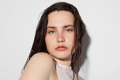 Photo of Portrait of beautiful woman with natural skin complexion on light grey background, closeup