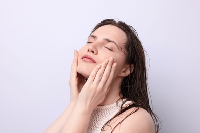 Photo of Beautiful woman with natural skin complexion on light grey background, closeup