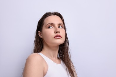 Photo of Beautiful woman with natural skin complexion on light grey background, closeup