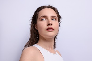 Photo of Beautiful woman with natural skin complexion on light grey background, closeup