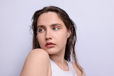 Photo of Beautiful woman with natural skin complexion on light grey background, closeup