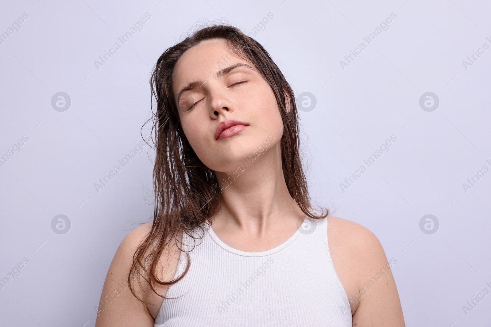 Beautiful woman with natural skin complexion on light grey background Photo of Beautiful woman with natural skin complexion on light grey background