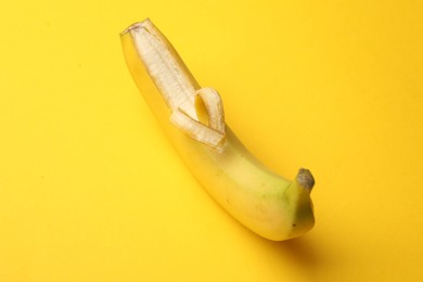 Photo of Banana with heart made of peel on yellow background, closeup