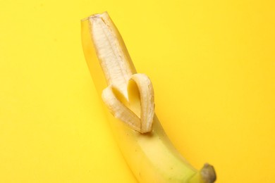 Photo of Banana with heart made of peel on yellow background, closeup