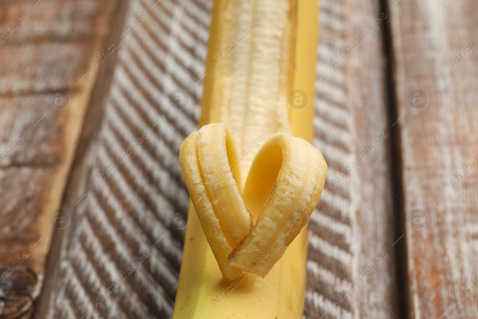 Banana with heart made of peel on wooden table, closeup Photo of Banana with heart made of peel on wooden table, closeup