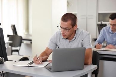 Photo of People studying at desks in library, selective focus