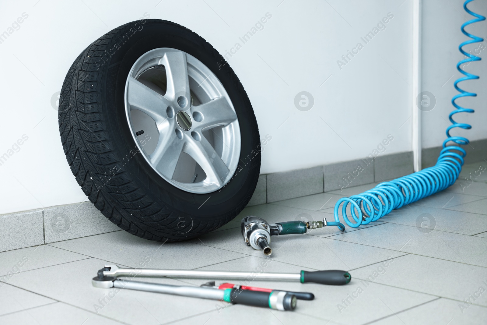 Photo of New tire and tools at car service