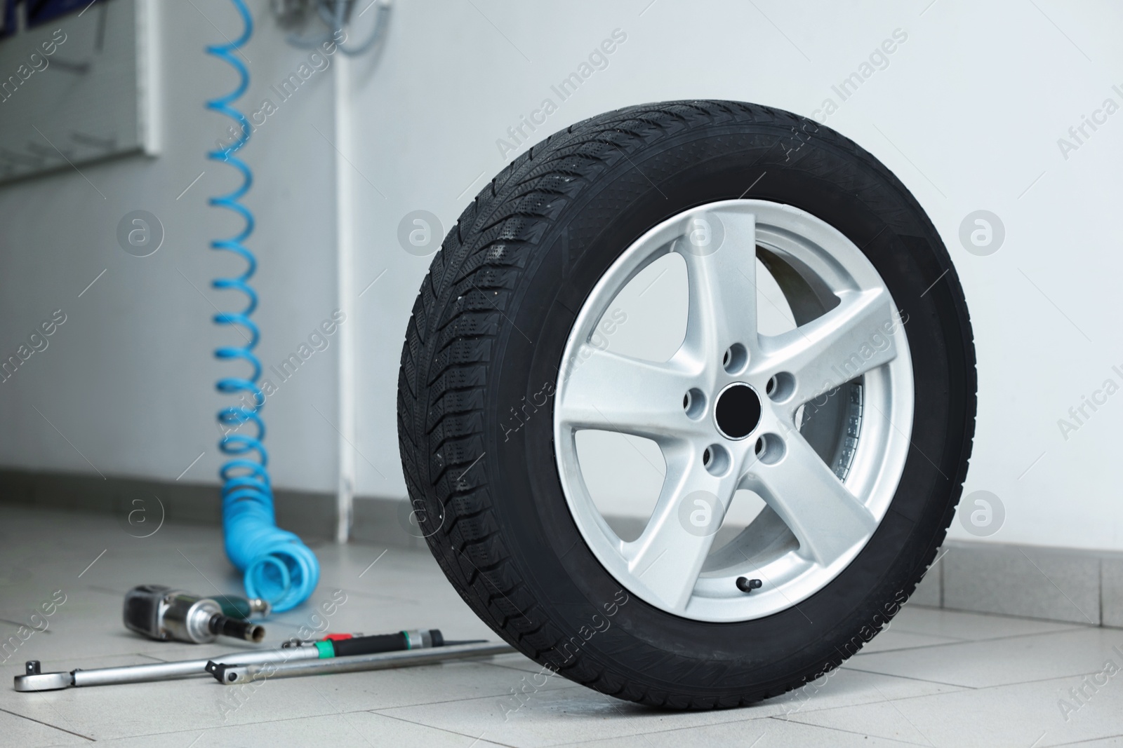 New tire and tools at car service Photo of New tire and tools at car service