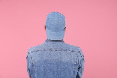 Photo of Young man wearing stylish denim baseball hat on pink background