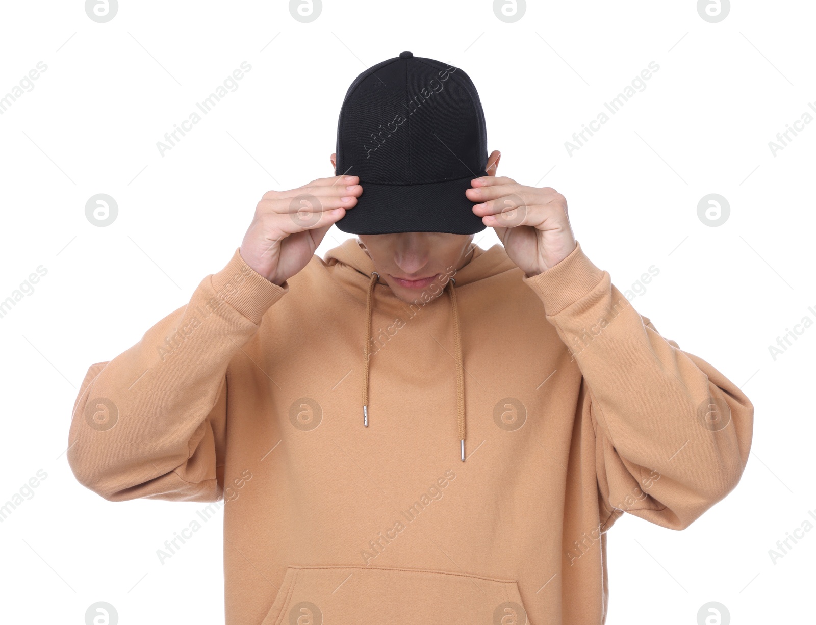 Young man wearing stylish black baseball hat on white background Photo of Young man wearing stylish black baseball hat on white background
