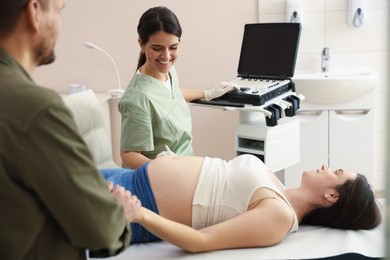 Photo of Woman and her husband attending prenatal ultrasound examination in clinic