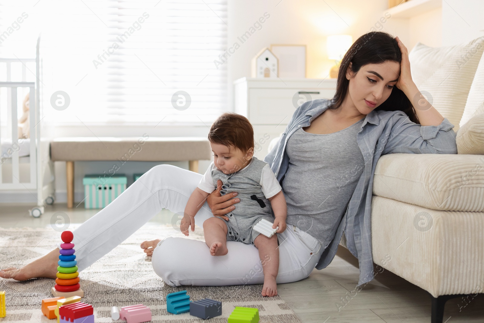 Woman suffering from postpartum depression with her little baby at home. Space for text Photo of Woman suffering from postpartum depression with her little baby at home. Space for text