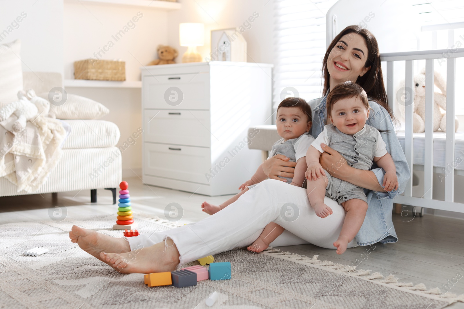 Mother with her cute twin babies at home Photo of Mother with her cute twin babies at home