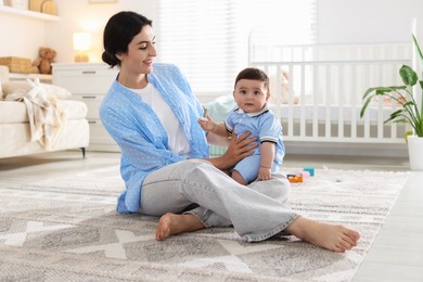 Photo of Mother with her cute baby at home