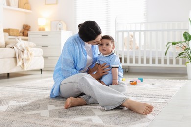 Photo of Mother with her cute baby at home