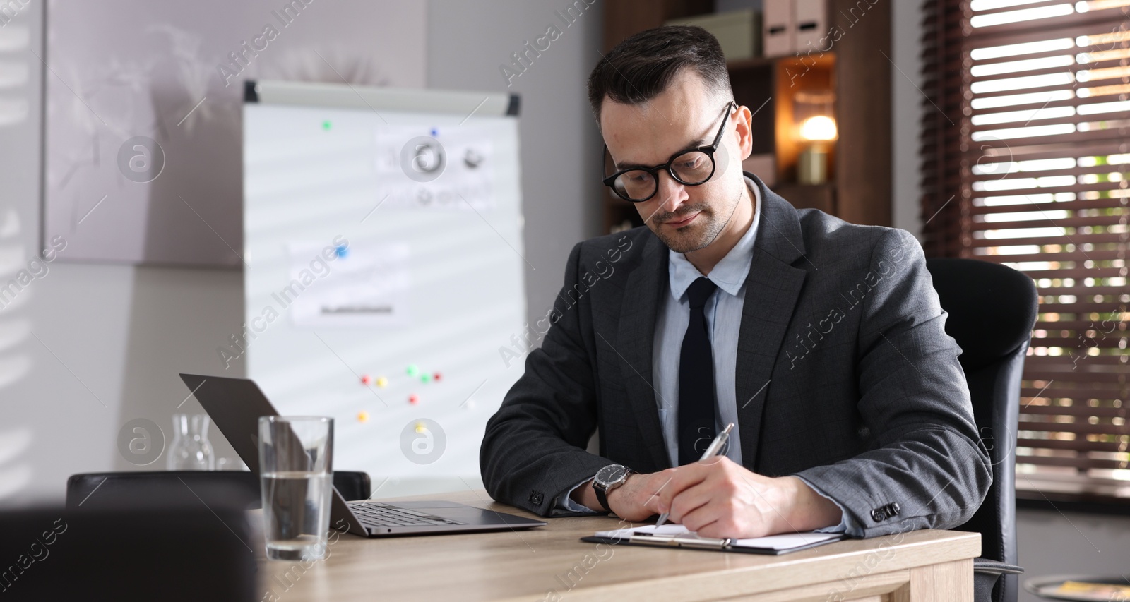 Marketing. Man working at wooden desk in office Photo of Marketing. Man working at wooden desk in office