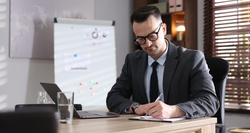 Photo of Marketing. Man working at wooden desk in office