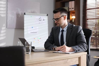 Photo of Marketing. Man working at wooden desk in office