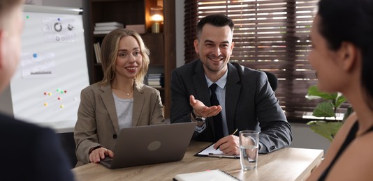 Photo of Marketing. Team of businesspeople working together at desk in office