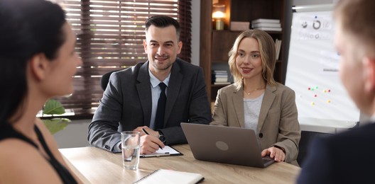 Photo of Marketing. Team of businesspeople working together at desk in office