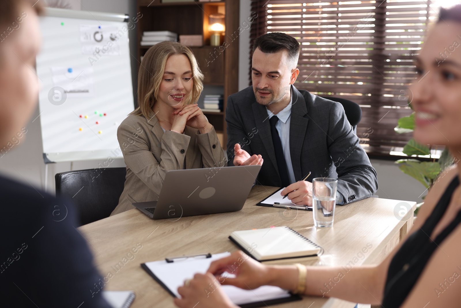 Marketing. Team of businesspeople working together at desk in office Photo of Marketing. Team of businesspeople working together at desk in office