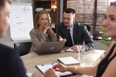 Photo of Marketing. Team of businesspeople working together at desk in office
