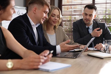 Photo of Marketing. Team of businesspeople working together at desk in office
