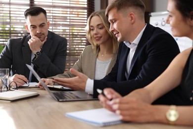 Photo of Marketing. Team of businesspeople working together at desk in office