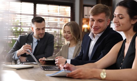 Photo of Marketing. Team of businesspeople working together at desk in office