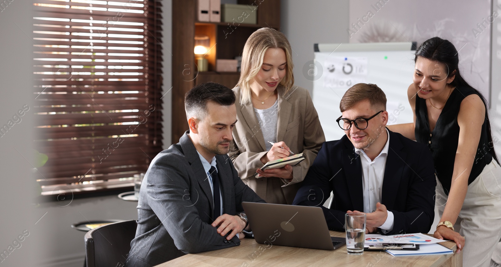 Photo of Marketing. Team of businesspeople working together at desk in office