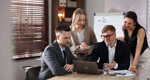 Photo of Marketing. Team of businesspeople working together at desk in office