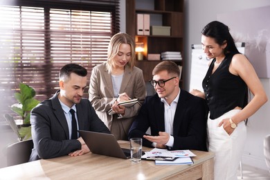 Photo of Marketing. Team of businesspeople working together at desk in office