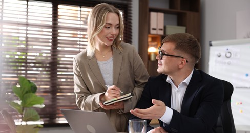 Photo of Marketing. Two colleagues working together in office