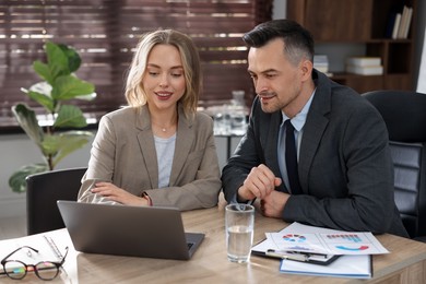 Photo of Marketing. Businesspeople working together at desk in office