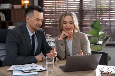 Photo of Marketing. Businesspeople working together at desk in office