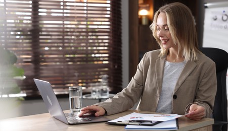 Photo of Marketing. Woman working with laptop at desk in office