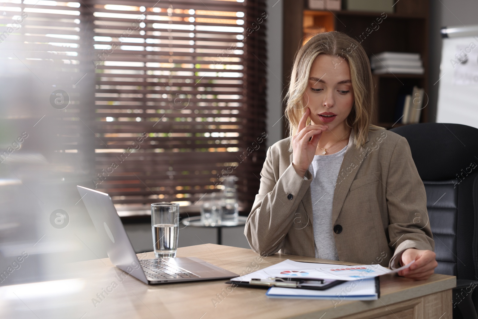 Marketing. Woman working at desk in office Photo of Marketing. Woman working at desk in office