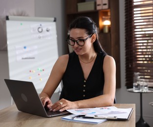 Photo of Marketing. Woman working with laptop at desk in office