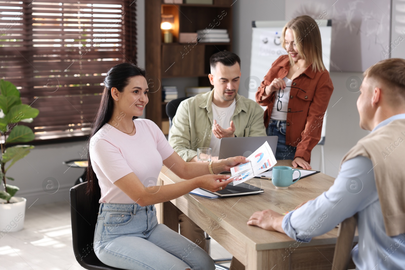 Marketing. Team of businesspeople working together at desk in office Photo of Marketing. Team of businesspeople working together at desk in office