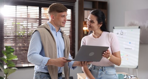 Photo of Marketing. Businesspeople with laptop working together in office