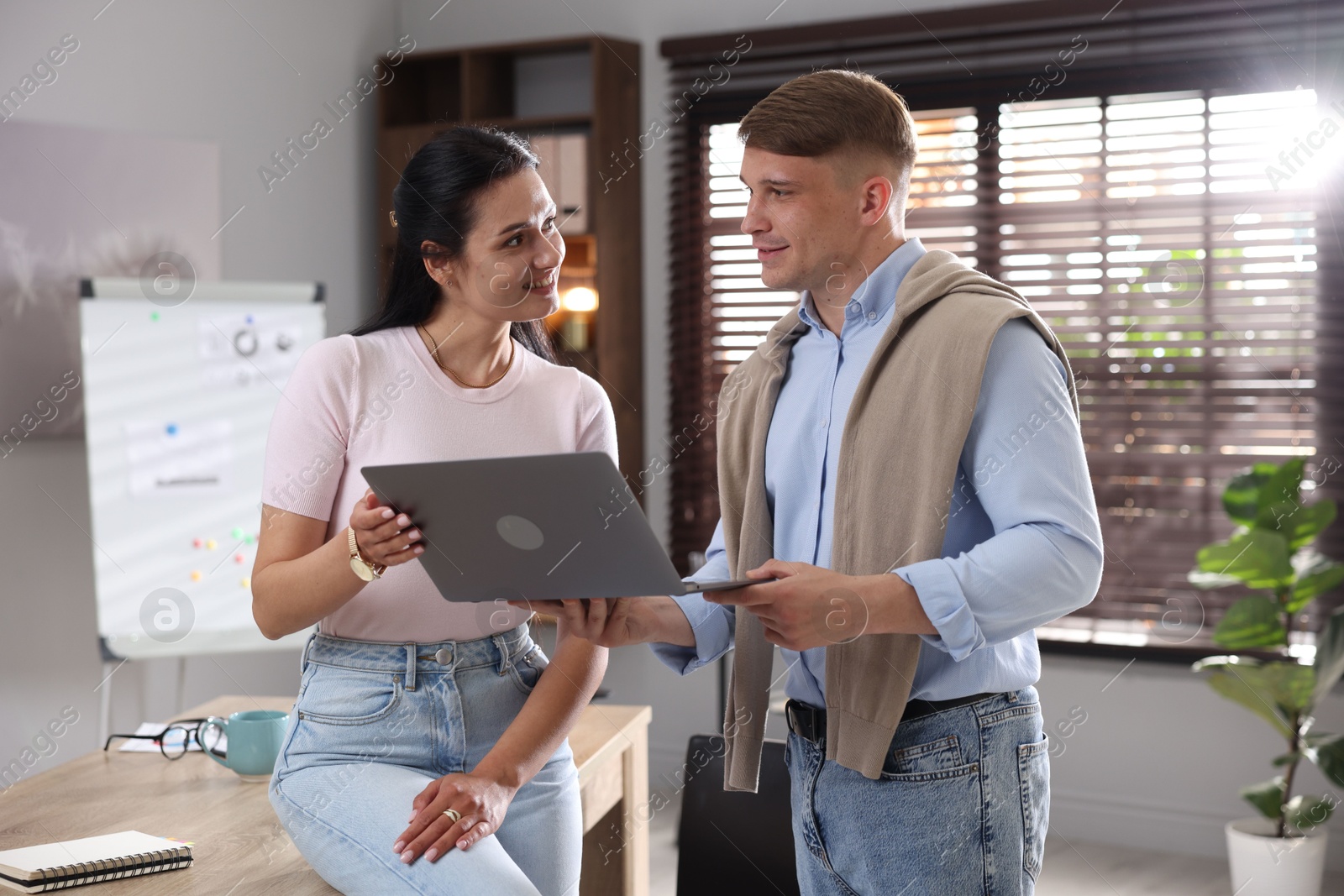 Marketing. Businesspeople with laptop working together in office Photo of Marketing. Businesspeople with laptop working together in office