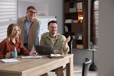 Photo of Marketing. Team of businesspeople working together at desk in office