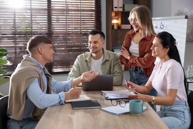 Photo of Marketing. Team of businesspeople working together at desk in office
