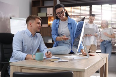 Photo of Marketing. Businesspeople working together at desk in office, selective focus