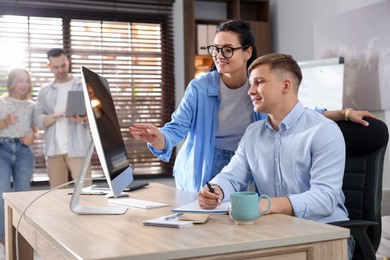 Photo of Marketing. Businesspeople working together at desk in office, selective focus