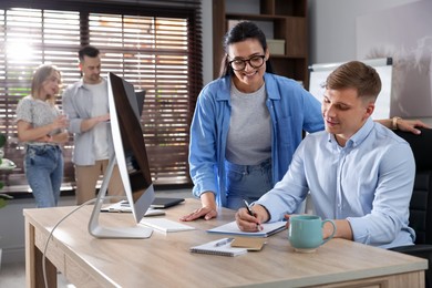 Photo of Marketing. Businesspeople working together at desk in office, selective focus